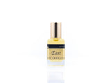15ml roller ball oil perfume bottle placed elegantly on a white background. The bottle is sleek and cylindrical, with a smooth glass body and a polished metal roller ball at the top. The label on the bottle is designed in gold and black, featuring Sifr Aromatics' logo and the perfume name 'East.' The overall aesthetic is clean and sophisticated, highlighting the high-quality craftsmanship of the product